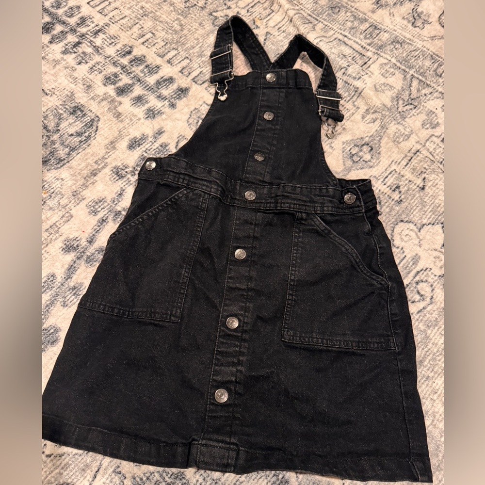 Overall skirt in a worn black denim. Colorful planet brand, size 14/16